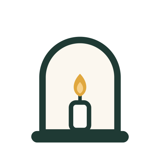 A candle burning in an arched window